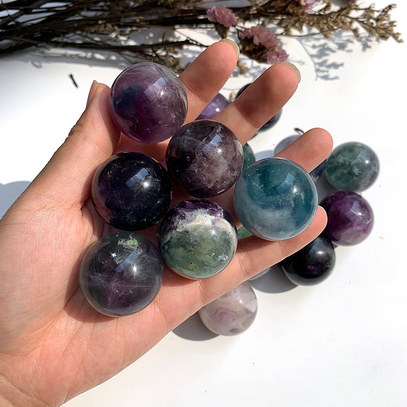 Natural Colorful Fluorite Sphere - hand-held scale view